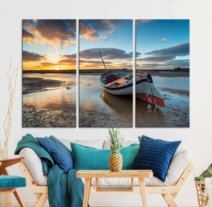 The "Small Boat At The Beach Sunset Wall Art Canvas Print," a three-panel masterpiece crafted on museum-quality canvas, hangs elegantly.