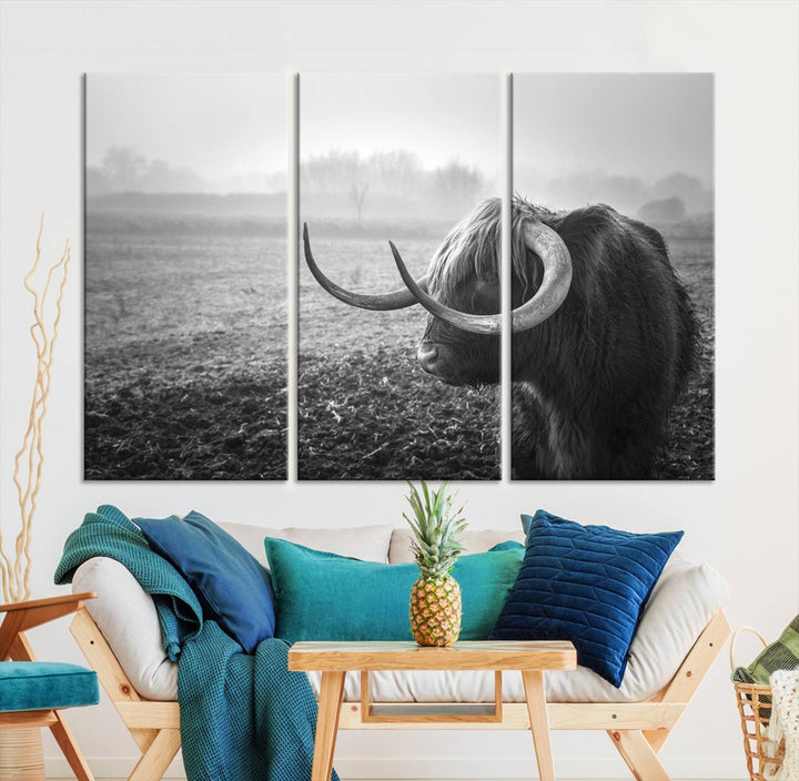 The living room features a three-panel wall art of a highland cow in a foggy field, using the Cow Wall Art Canvas Print for visual impact. This museum-quality canvas includes UV-protective coating to ensure longevity.