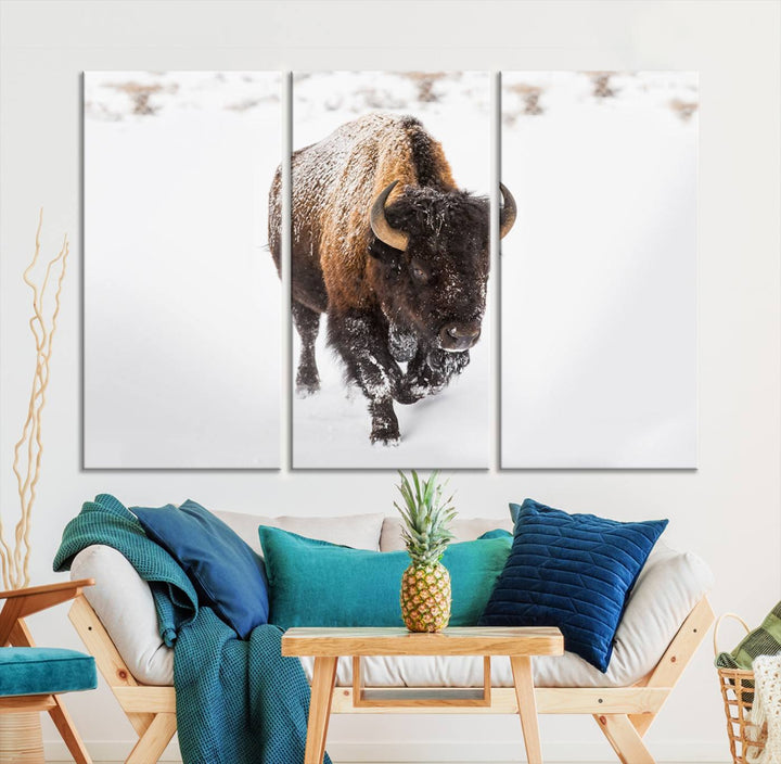 The Bison Winter Wall Art Canvas Print for Farmhouse Decor is displayed as a triptych in the living room. This artwork, printed on museum-quality canvases with a UV-protective coating to maintain its vibrant colors, is the focal point of the space.