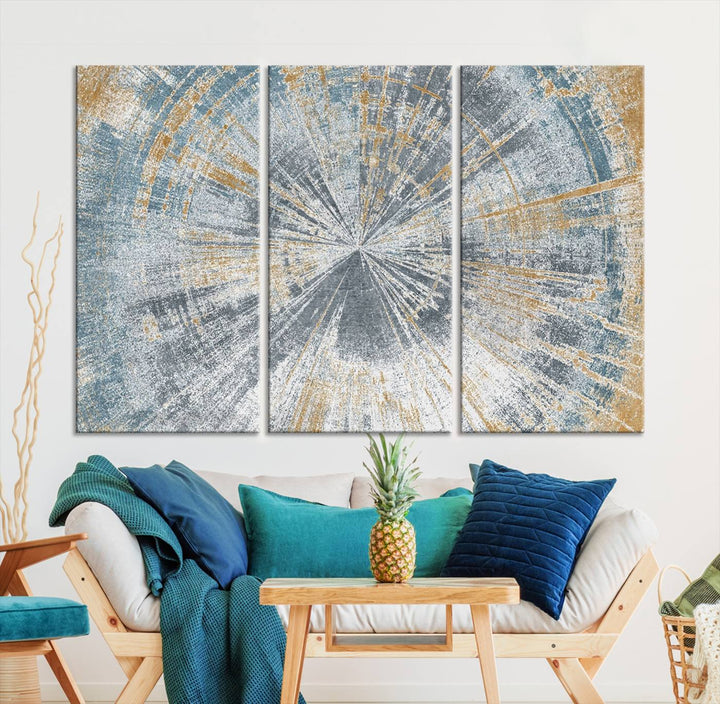 The Radiant Abstract Wood Rings Canvas Art, a modern triptych wall decor, enhances the contemporary style of the living room with its blue, white, and gold hues.