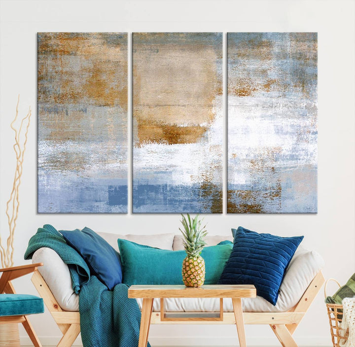 The Blue Multi Panel Abstract Wall Art Canvas Print, featuring an elegant blend of blue, beige, and brown tones, hangs gracefully on the wall, adding a contemporary touch to the space.