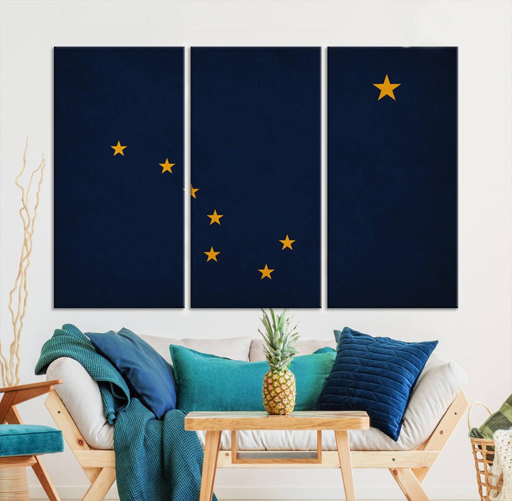 A contemporary living room featuring a triptych artwork of stars on a navy background, accentuated by the striking Alaska States Flag Wall Art Canvas Print.