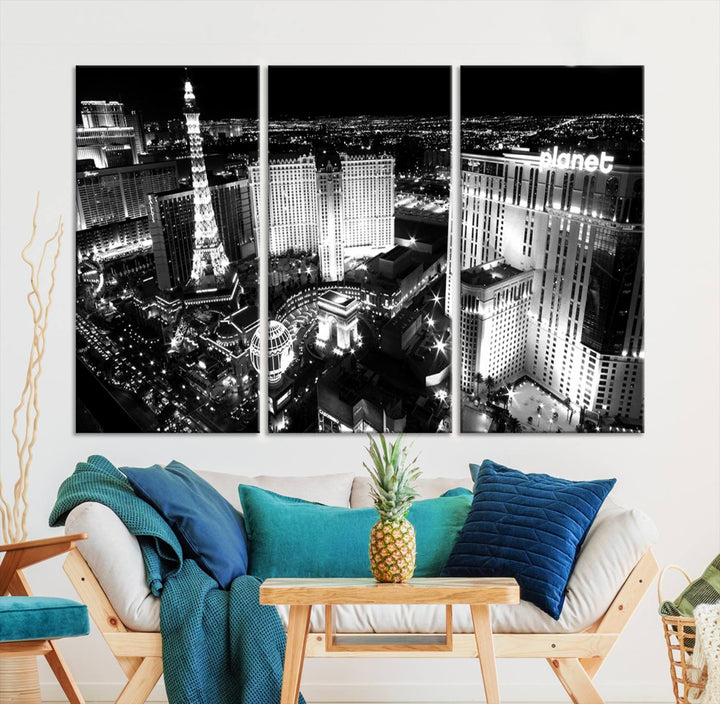 The Las Vegas Wall Art Canvas Print is a black and white triptych that showcases a city skyline at night. Crafted on museum-quality canvas with a UV-protective coating, it serves as an elegant and ready-to-hang focal point in the room.