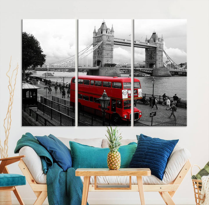 The London Red Bus and Bridge Wall Art Canvas Print showcases a red London bus in front of Tower Bridge, beautifully presented as a gallery-wrapped canvas. This striking image is divided into three panels, delivering a museum-quality display that's ready to hang.