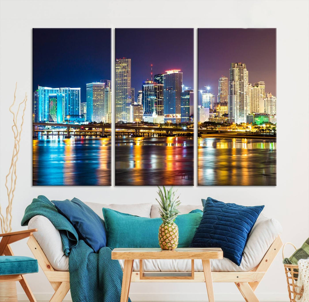 The Wall Art MIAMI Canvas Print features a stunning triptych of a city skyline at night, with vibrant lights reflecting on the water. This gallery-wrapped piece on museum-quality canvas delivers an exquisite finish.