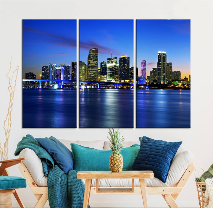 The modern living room showcases a striking Miami Blue Night Wall Art canvas print on the wall. The artwork is gallery wrapped on museum-quality canvas, ensuring durability and elegance.