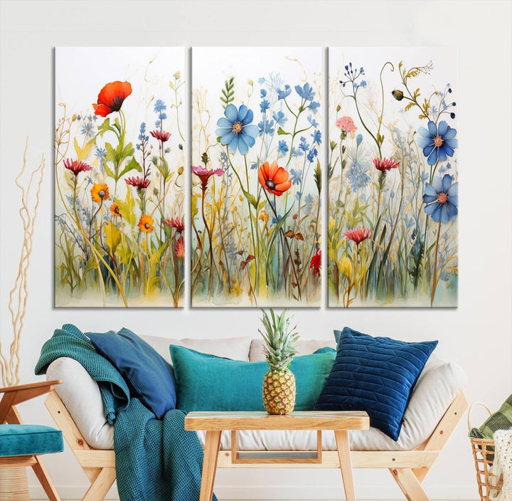 The Colorful Wildflower Canvas Wall Art – Vibrant Floral Botanical Print, consisting of a large 3 panel set, adds bright nature decor to the living room against a black wall.