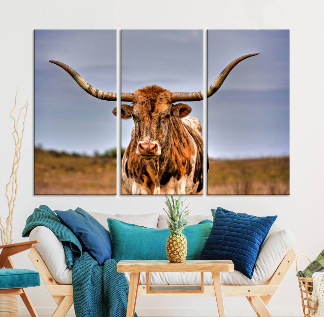 The Texas Longhorn Wall Art Print, a triptych canvas artwork depicting a longhorn bull in a field, features a gallery-quality finish.