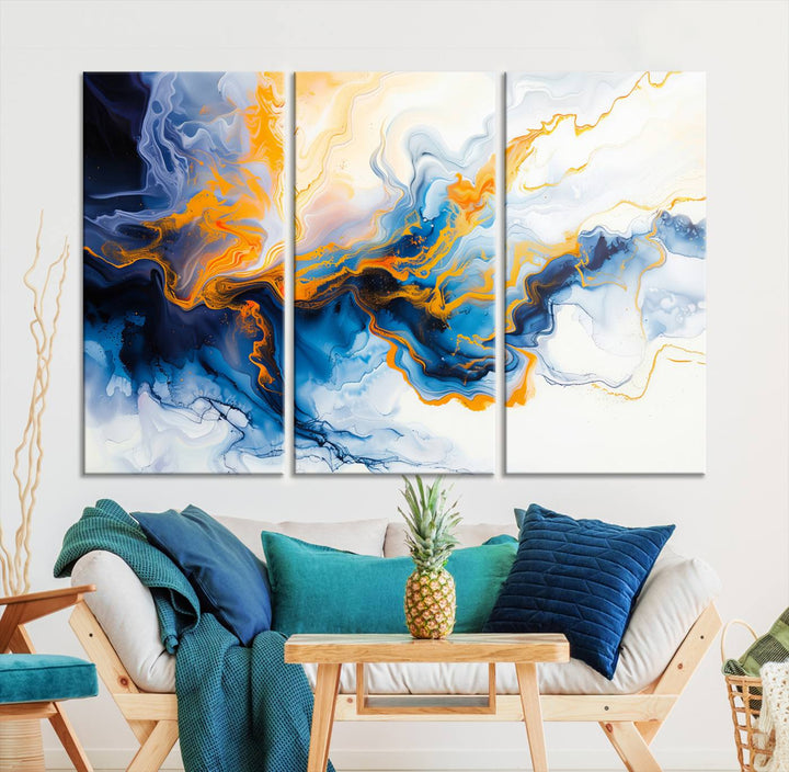 A stunning Fluid Alcohol Ink Wall Art with Gold Wall Art Canvas Print, featuring vibrant blue, orange, and white swirls, adorns the wall. This gallery-quality finish adds an exquisite touch to any living space.