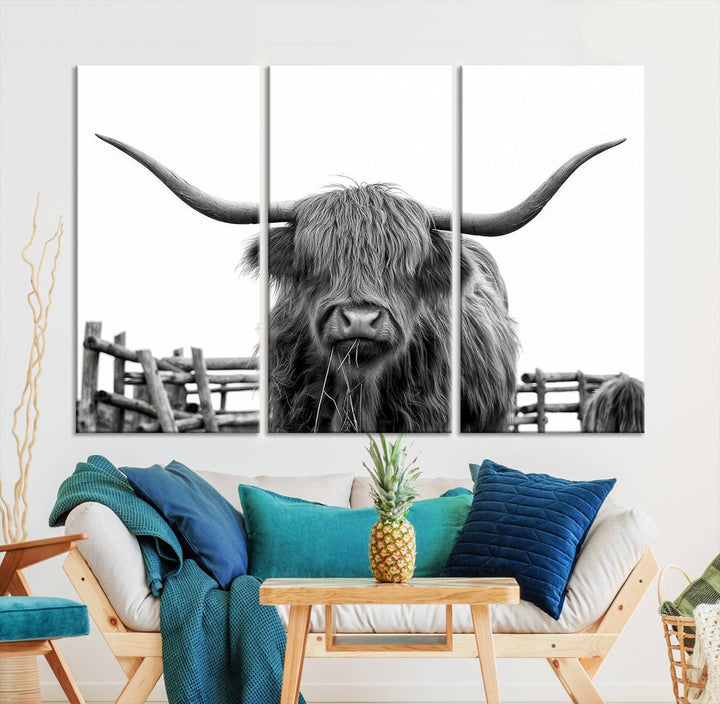 The Longhorn Canvas Print, featuring a black-and-white triptych of a Bighorn cow with shaggy fur and impressive long horns, is elegantly showcased. This wall art piece boasts a gallery-quality finish on premium canvas, bringing sophistication to any room.