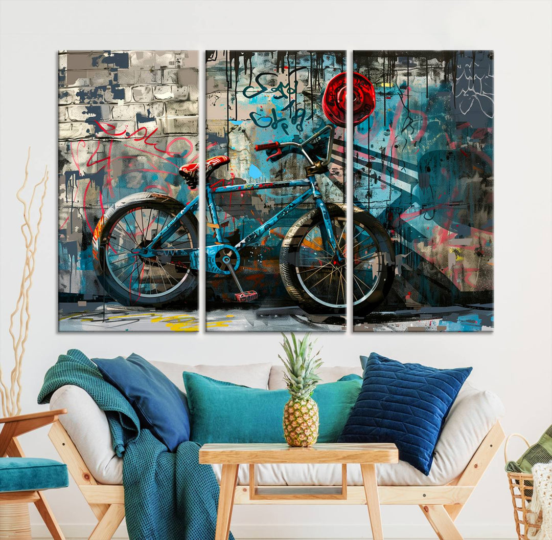 A modern living room features a triptych wall art of an abstract bicycle, designed in a graffiti style on a brick wall. This piece is expertly crafted on the Abstract Bicycle Wall Art Canvas Print, offering a premium canvas that ensures a gallery-quality finish.