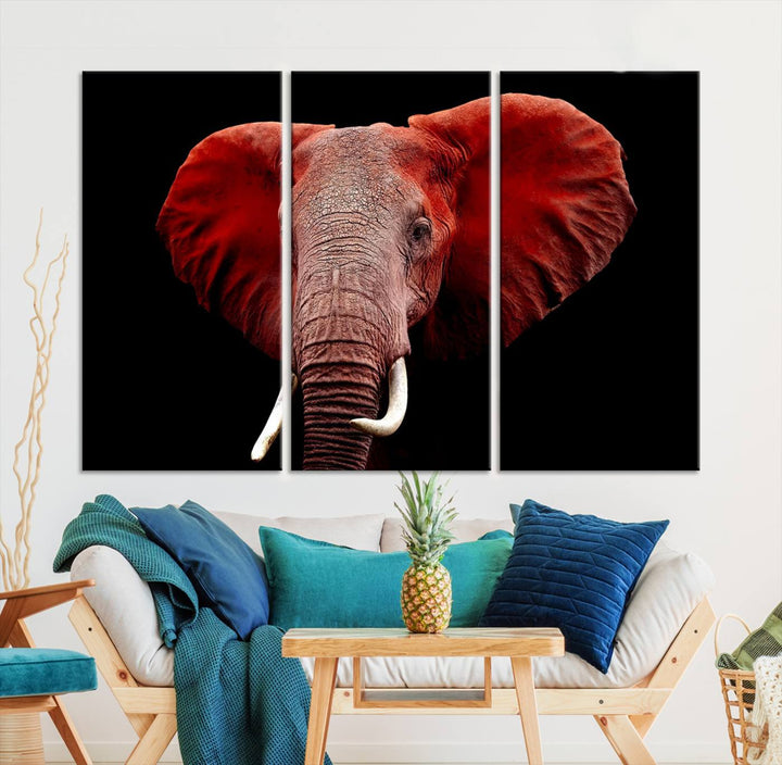 A Wall Art Canvas Print in the modern living room features a three-panel premium design of a red elephant face.