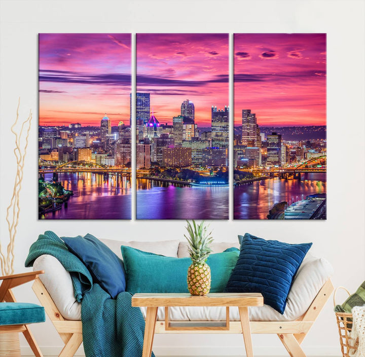 The Pittsburg Wall Art Canvas Print, showcasing a vibrant sunset glow over the city skyline and crafted by a professional artisan, adorns the space.