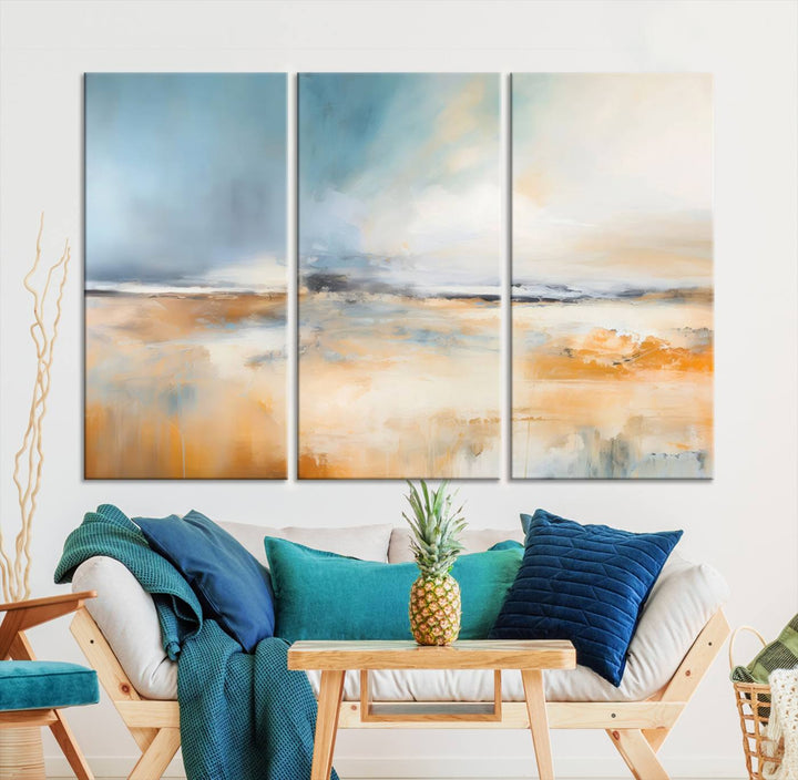 The Abstract Landscape Wall Art Canvas Print, featuring warm tones of orange and blue, is displayed on a dark wall.