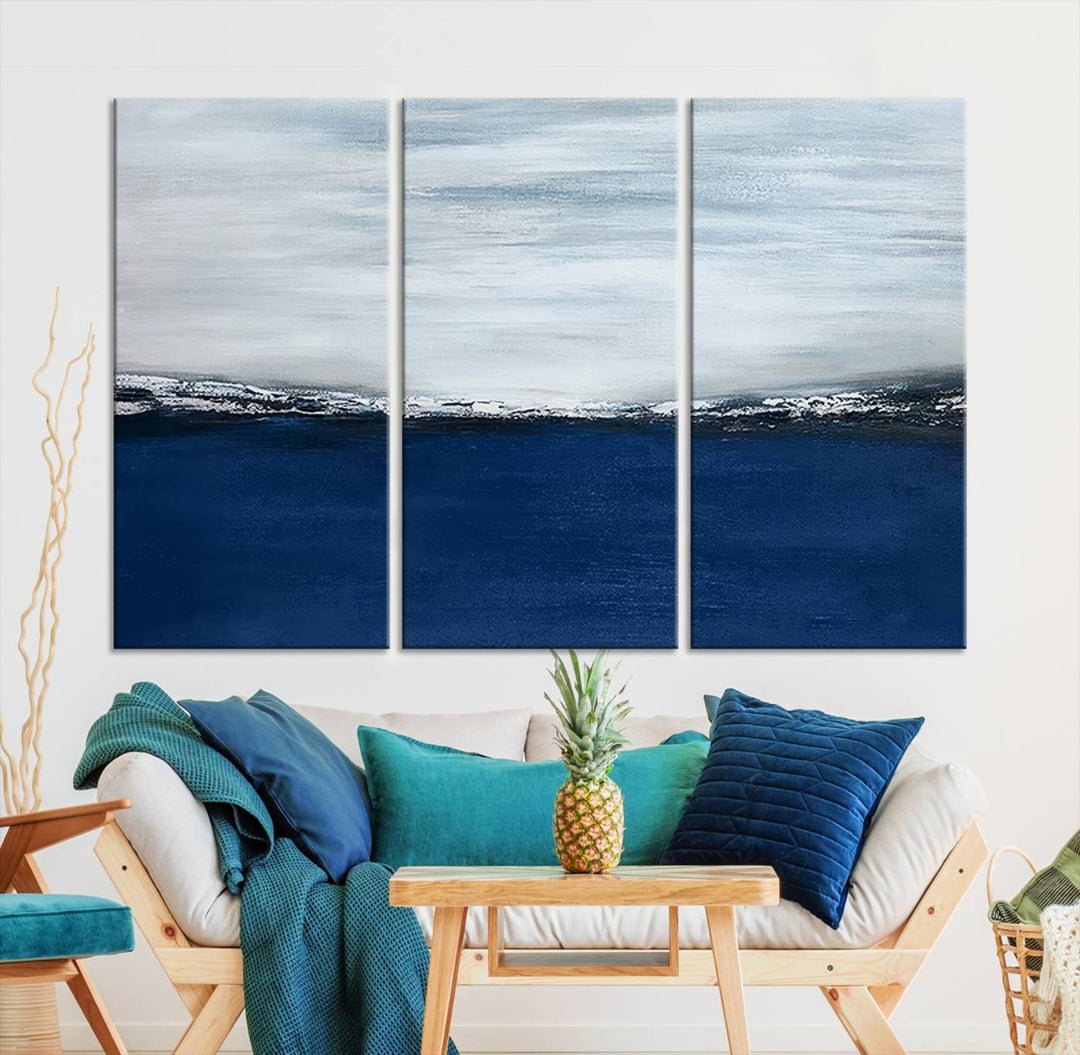 The modern living room is enhanced by the Navy Blue Abstract Wall Art Canvas Print on the wall, crafted as handmade wall art with a gallery-quality finish.