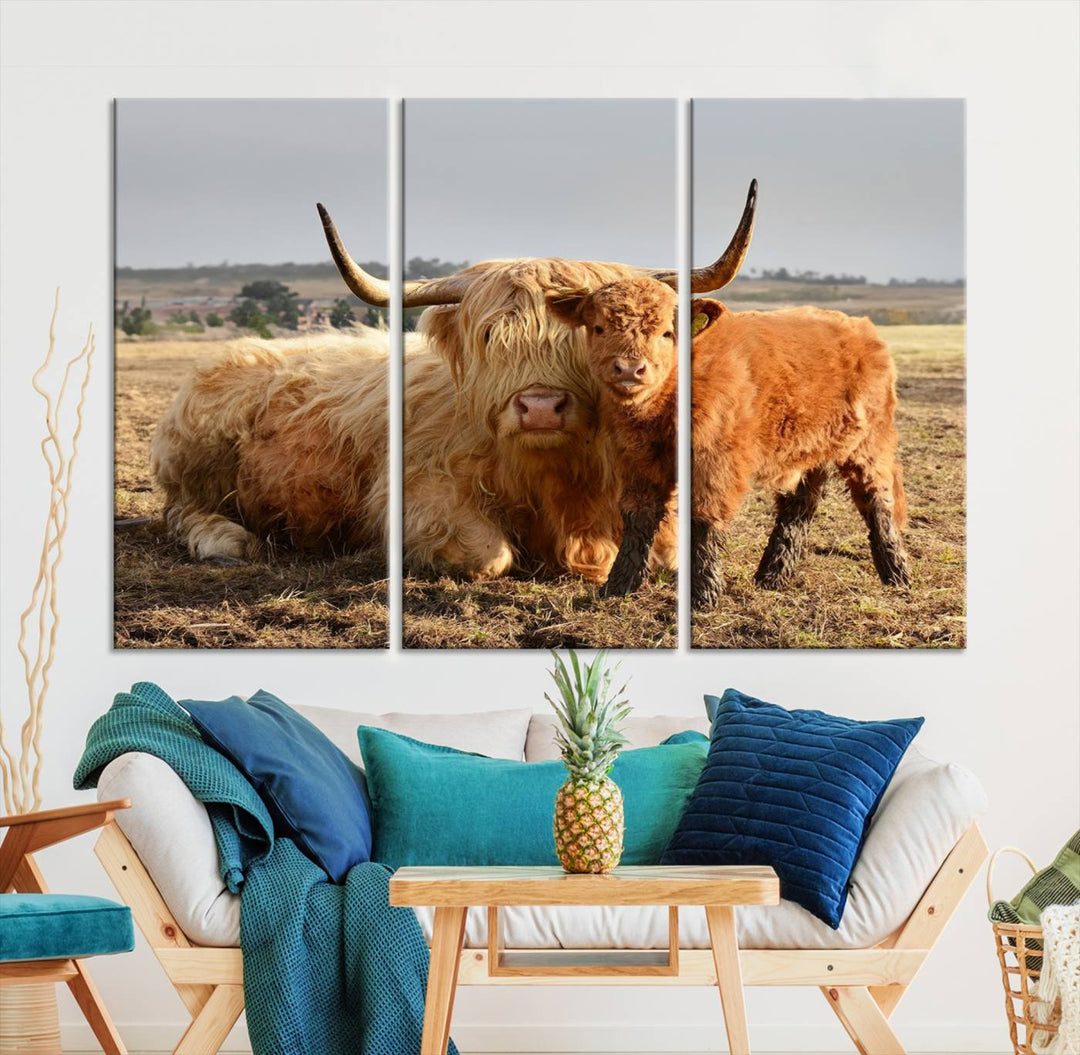 The three-panel canvas artwork, titled "Highland Cow Canvas Wall Art Animal Print for Farm House Decor," features a serene scene of a resting Highland cow and calf in a field. The piece highlights its gallery-quality finish.