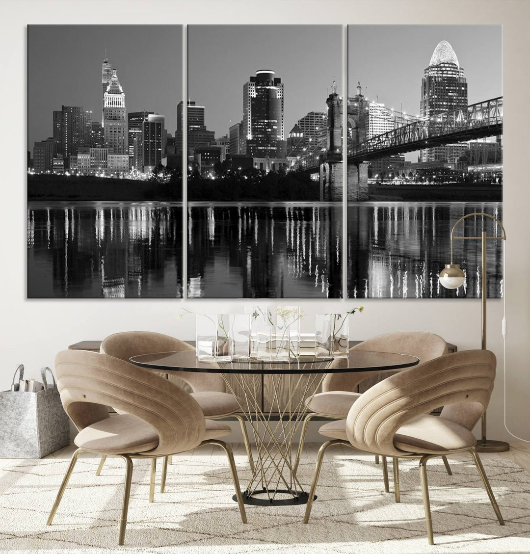 The wall showcases a ready-to-hang triptych of the Cincinnati City Lights Skyline in black and white, printed on museum-quality canvas.