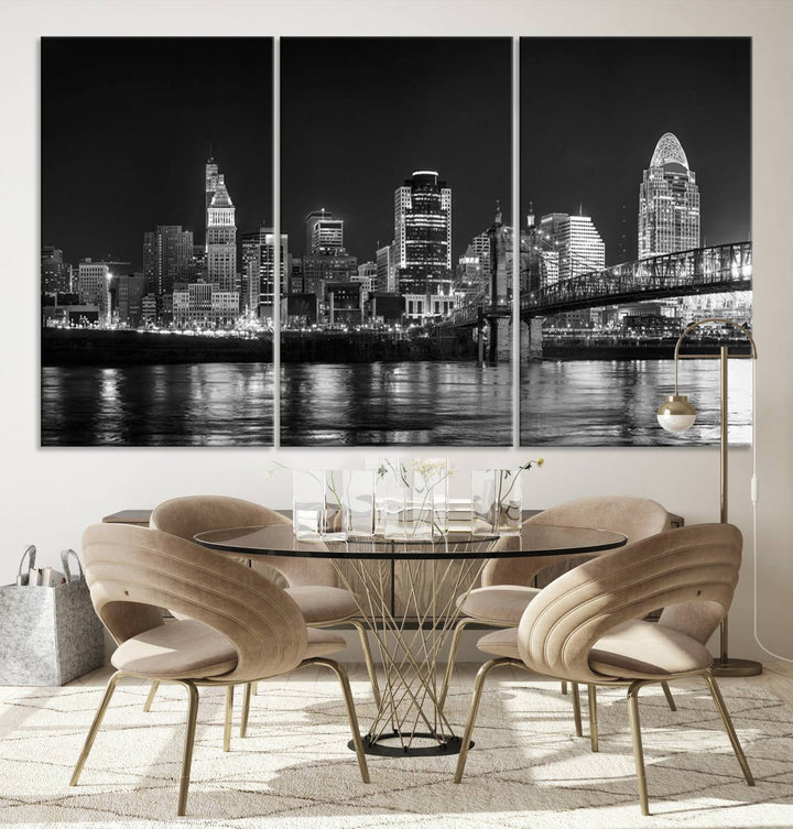 The Cincinnati City Lights Skyline Black and White Wall Art Cityscape Canvas Print elegantly adorns a modern living room. This museum-quality canvas triptych of a city skyline is enhanced by hand-assembled frames for added finesse, and you can enjoy free shipping on this stunning home addition.