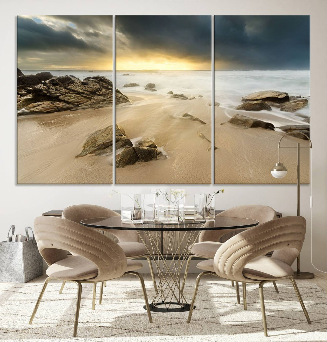 A gallery-wrapped, three-panel artwork titled "Rocks and Waves Wall Art Canvas Print" depicts a rocky beach at sunset. Each canvas showcases museum-quality craftsmanship and a UV-protective coating to maintain its vibrant colors.