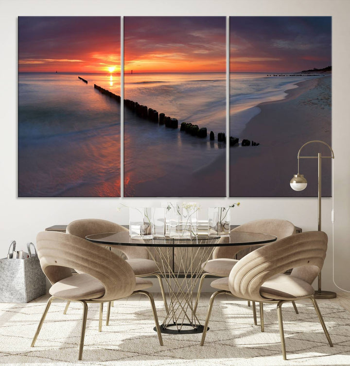 In a modern living room, the Sunset Beach Wall Art Canvas Print is displayed above. This triptych, printed on museum-quality canvas with a UV-protective coating, ensures lasting brilliance. It's ready to hang and brings an elegant touch to your space.