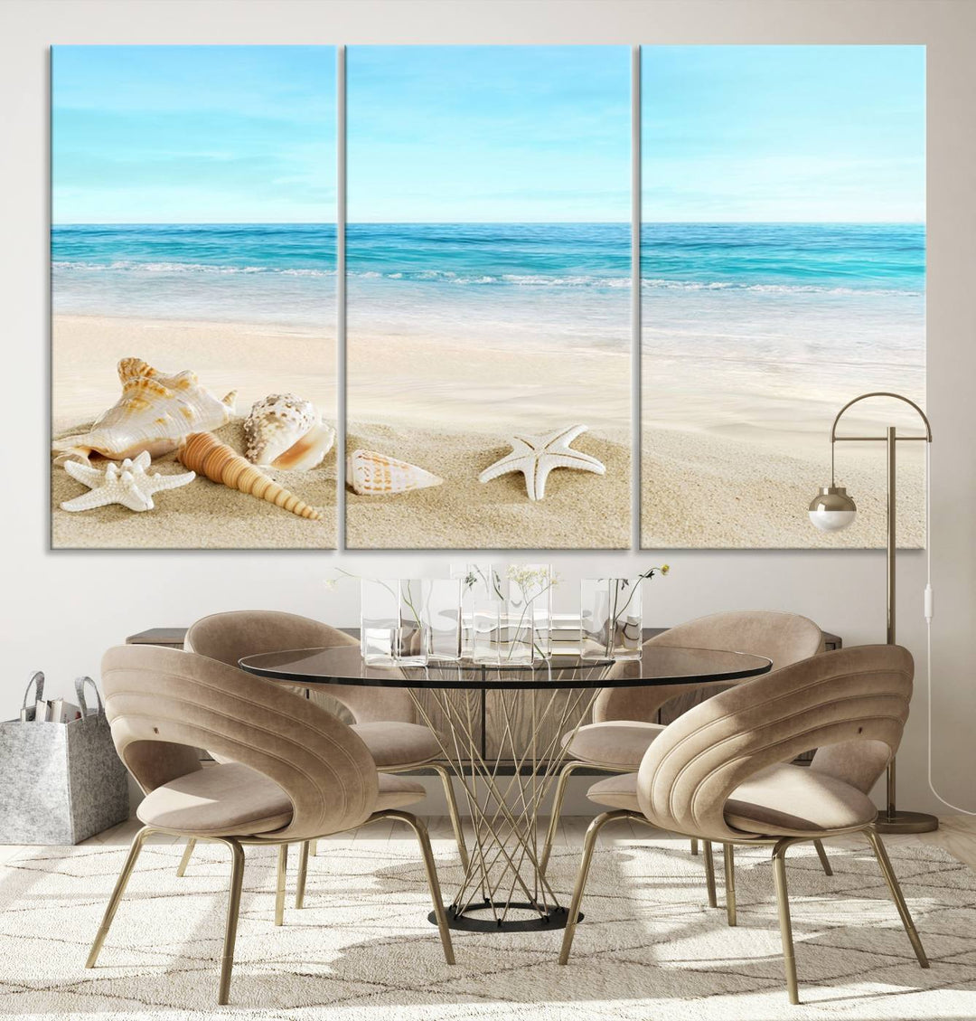 The "Turquoise Ocean View Seashell Starfish on the Beach Canvas Print Artwork" is a triptych piece that showcases a tranquil beach scene, complete with seashells and starfish adorning the sand. It is elegantly gallery-wrapped on museum-quality canvas.