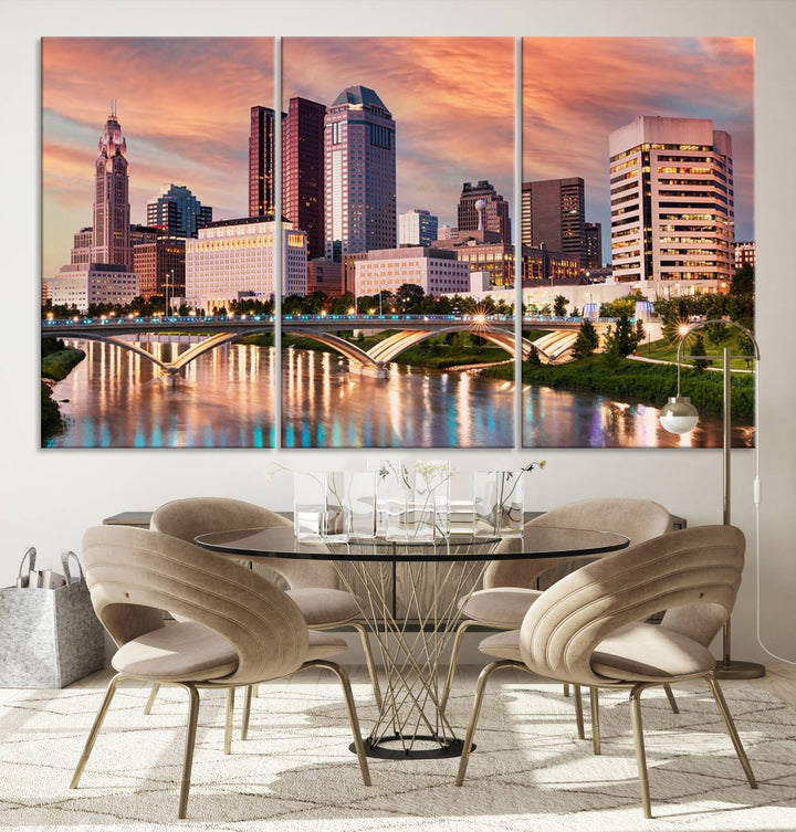 The "Columbus City Lights Sunset Orange Cloudy Skyline Cityscape View" wall art is featured on the wall. This triptych is printed on museum-quality canvas and includes a UV-protective coating, ensuring lasting vibrancy.