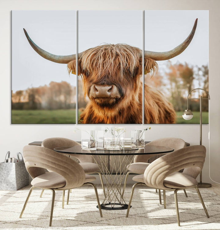 A Highland Cow Animal Scottish Cattle Art Print Farmhouse Wall Art Canvas Print hangs in the living room, adding a touch of rustic farmhouse decor.