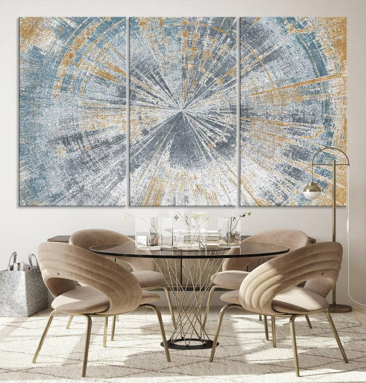 The Radiant Abstract Wood Rings Canvas Art, a modern triptych wall decor, enhances the contemporary style of the living room with its blue, white, and gold hues.