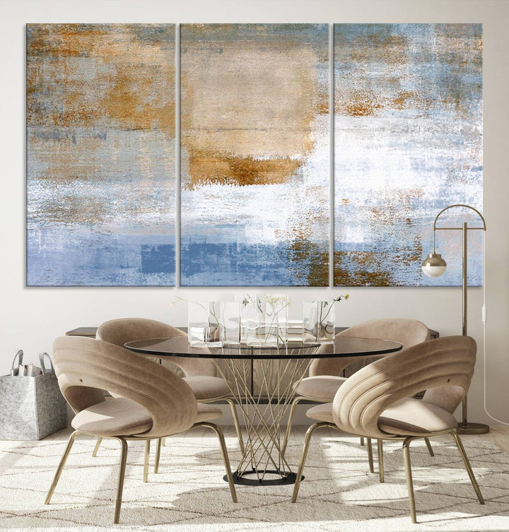 The Blue Multi Panel Abstract Wall Art Canvas Print, featuring an elegant blend of blue, beige, and brown tones, hangs gracefully on the wall, adding a contemporary touch to the space.