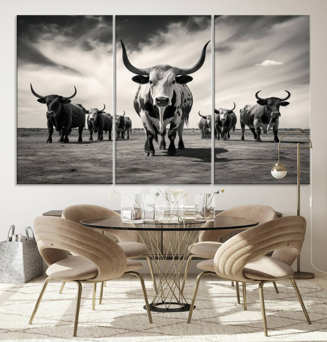 The Black and White Longhorn Cattle Wall Art, featuring a three-panel display of cowboy Western longhorns walking toward the viewer, enhances your space with its striking presence, adding a touch of Western decor.