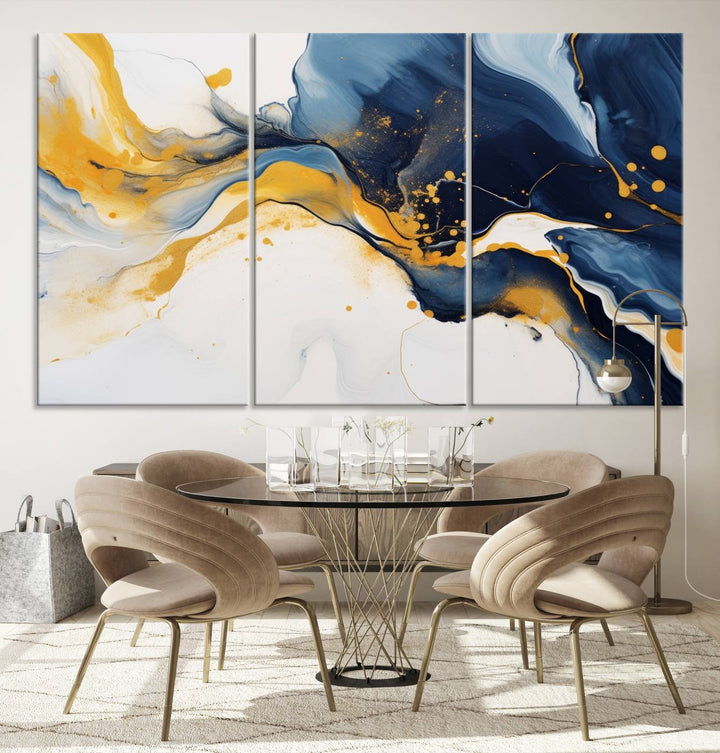 The Blue and Gold Abstract Fluid Canvas Art, with its swirling patterns, adorns the wall. This modern wall art beautifully complements the contemporary interior decor, adding an elegant touch with its rich blue, gold, and white tones.