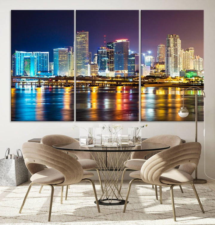 The Wall Art MIAMI Canvas Print features a stunning triptych of a city skyline at night, with vibrant lights reflecting on the water. This gallery-wrapped piece on museum-quality canvas delivers an exquisite finish.