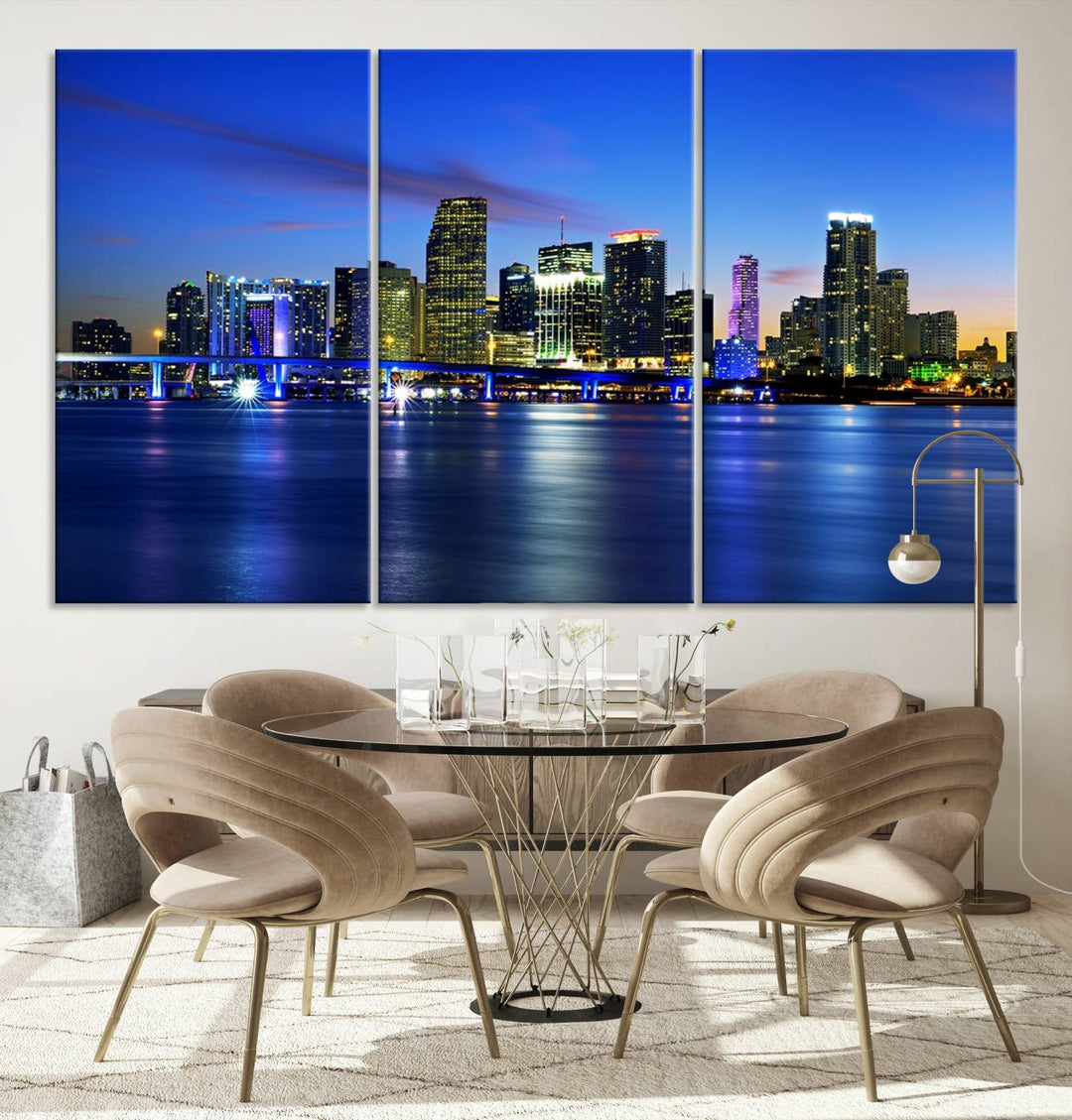 The modern living room showcases a striking Miami Blue Night Wall Art canvas print on the wall. The artwork is gallery wrapped on museum-quality canvas, ensuring durability and elegance.