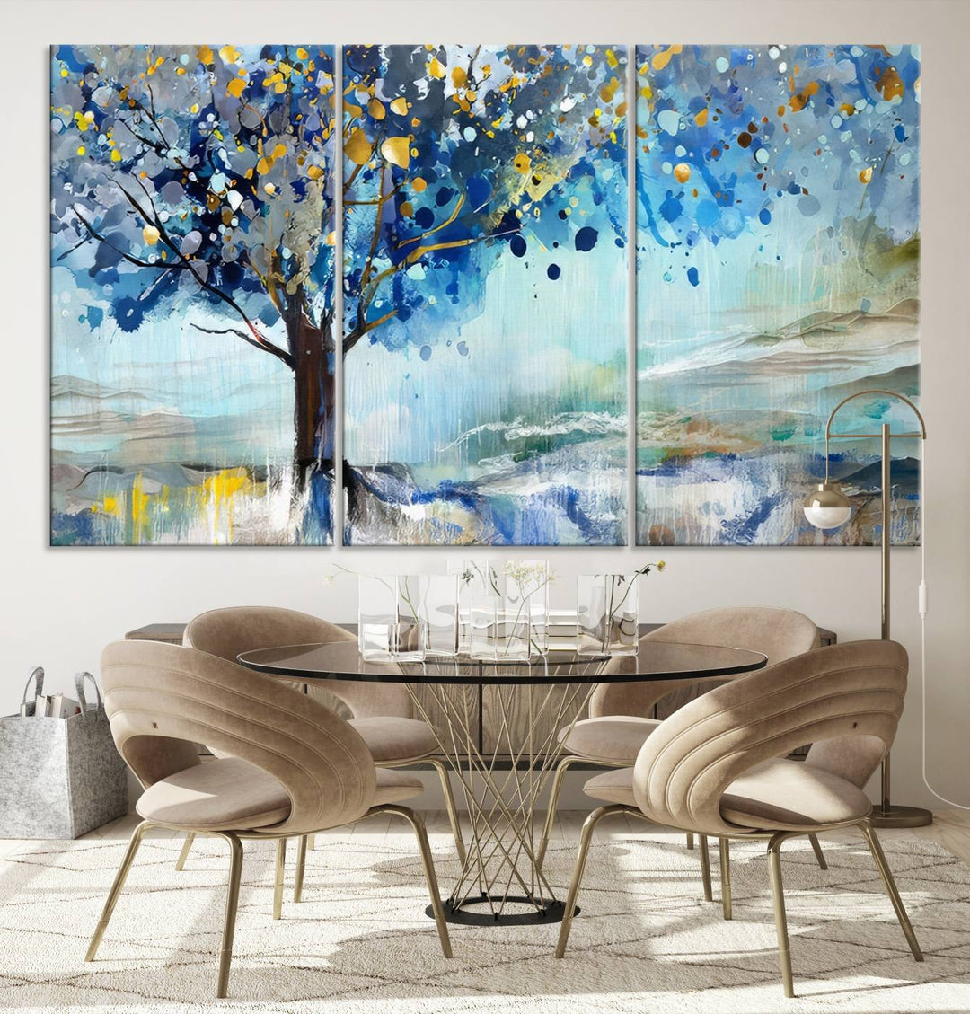 A modern living room features a three-panel Watercolor Style Abstract Tree Printing Wall Art Canvas in vibrant blue and yellow, crafted on museum-quality material.