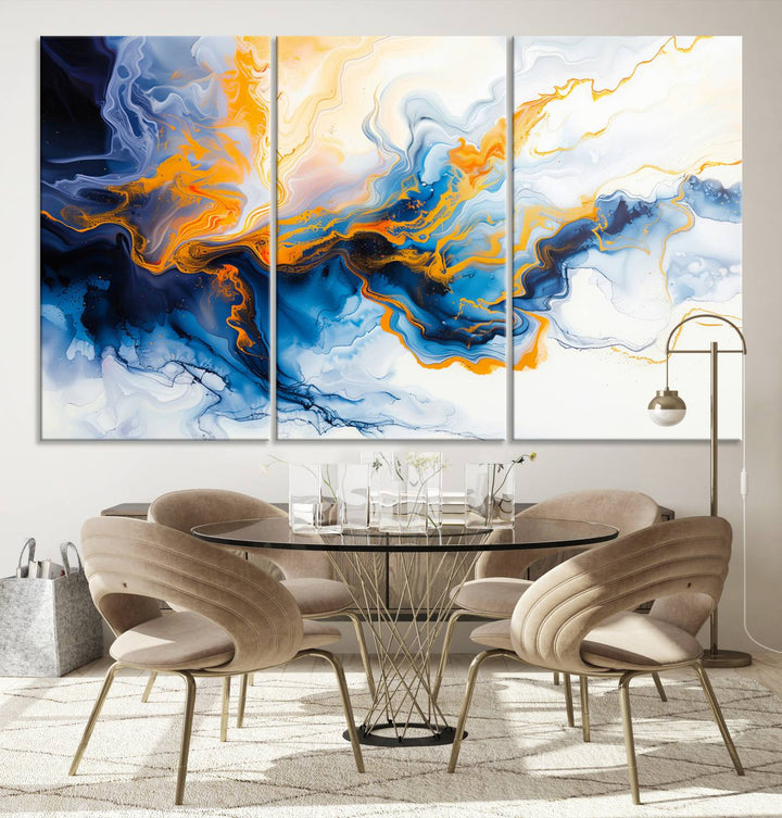 A stunning Fluid Alcohol Ink Wall Art with Gold Wall Art Canvas Print, featuring vibrant blue, orange, and white swirls, adorns the wall. This gallery-quality finish adds an exquisite touch to any living space.