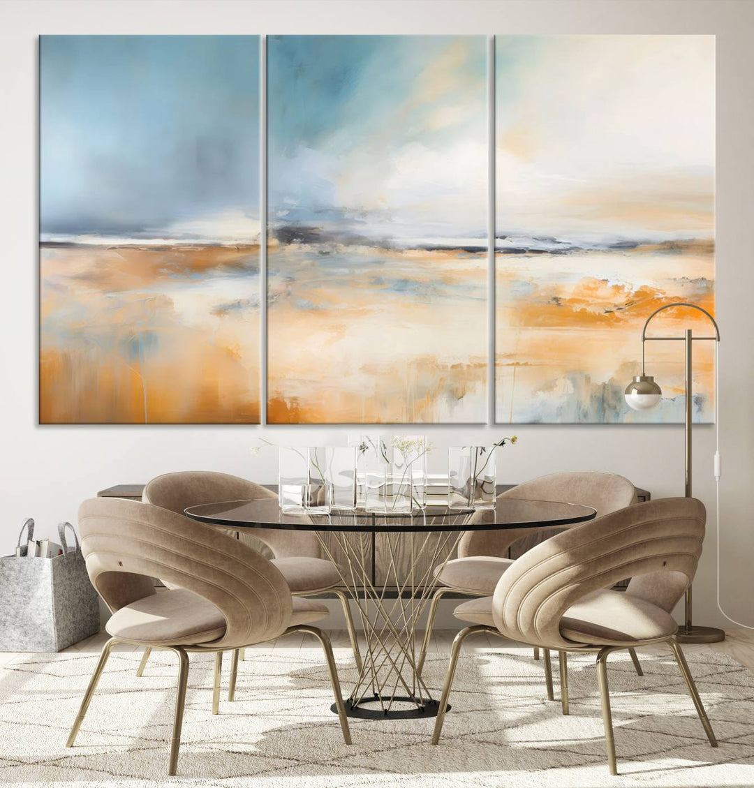 The Abstract Landscape Wall Art Canvas Print, featuring warm tones of orange and blue, is displayed on a dark wall.