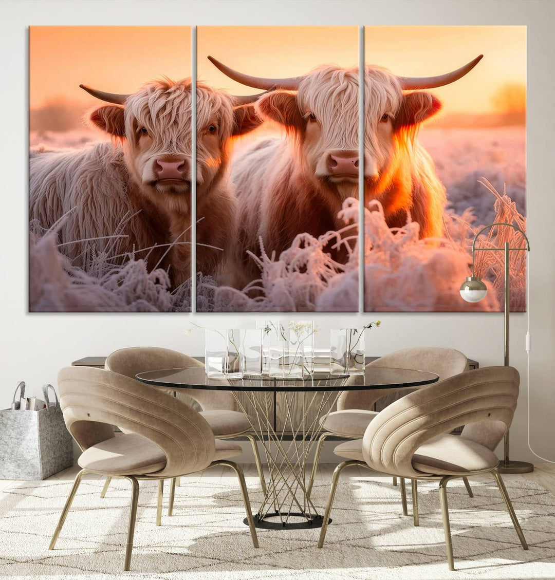 The "Highland Cows at Sunrise Wall Art Canvas Set" beautifully captures a serene and rustic farmhouse aesthetic, portraying two Highland cows in a frosty landscape at sunrise.