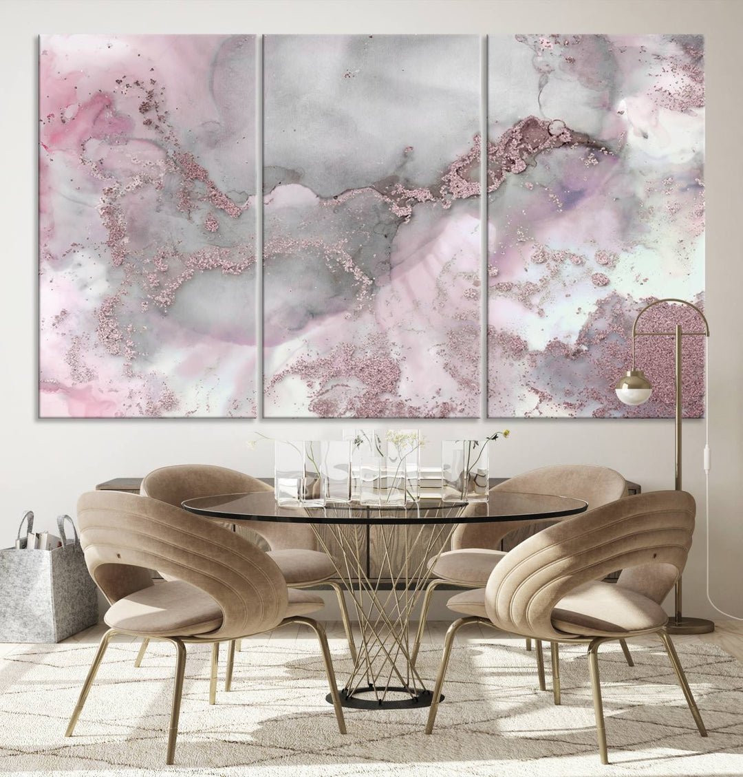 The Rose Marble Abstract Wall Art Canvas Print is a stunning triptych that showcases pink and gray tones, elegantly presented on a dark wall.