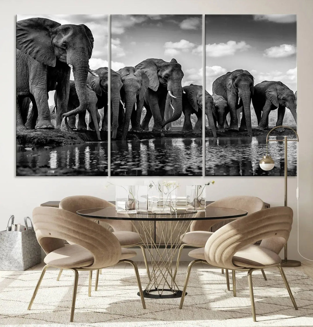 A stunning "Wall Art Animal Canvas Print" featuring a black and white photo of a herd of elephants drinking water is elegantly displayed, gallery wrapped on museum-quality canvas.