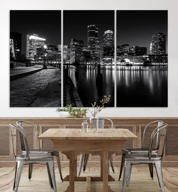 The Boston City Lights Skyline Black and White Wall Art Cityscape Canvas Print portrays a triptych of the city skyline at night reflecting on a calm river. This museum-quality canvas features UV-protective finishes to preserve its timeless allure.