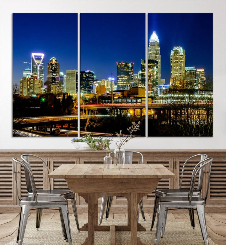 The Charlotte City Lights Night Blue Skyline Cityscape View Wall Art Canvas Print, showcasing an illuminated city skyline at night, is printed on museum-quality canvas with a UV-protective coating. Enhance your space with this stunning piece and enjoy free shipping with your purchase.