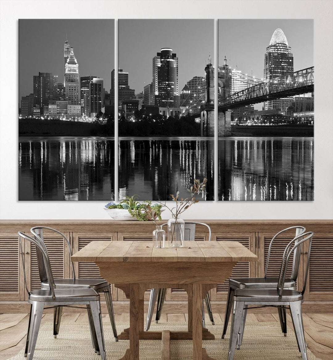 The wall showcases a ready-to-hang triptych of the Cincinnati City Lights Skyline in black and white, printed on museum-quality canvas.