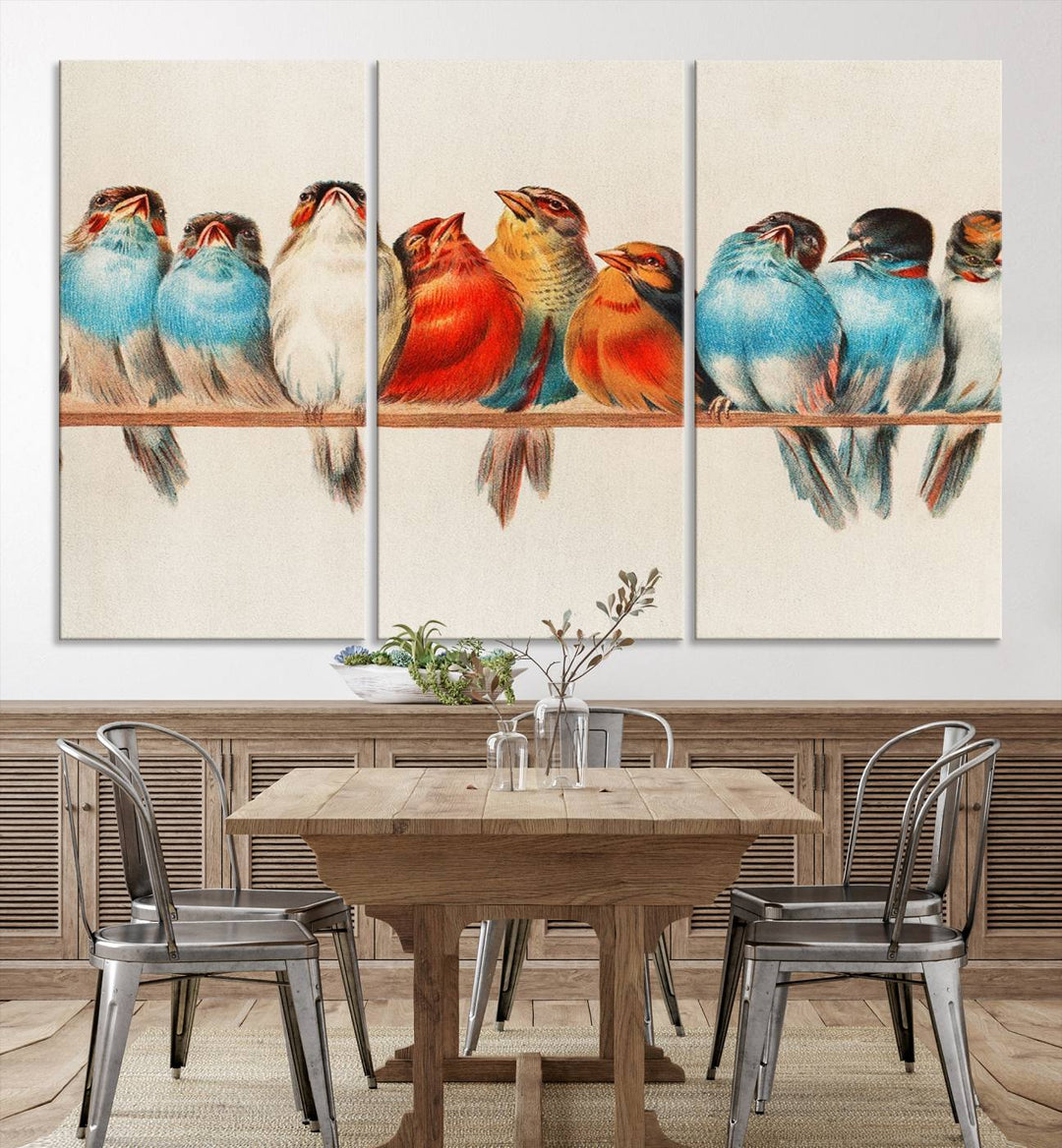 The Abstract Birds Wall Art Canvas Print, featuring a triptych of colorful birds perched on a branch, is printed on museum-quality canvas and equipped with a UV-protective coating and ready-to-hang design. This artwork adds vibrant elegance to your living space.