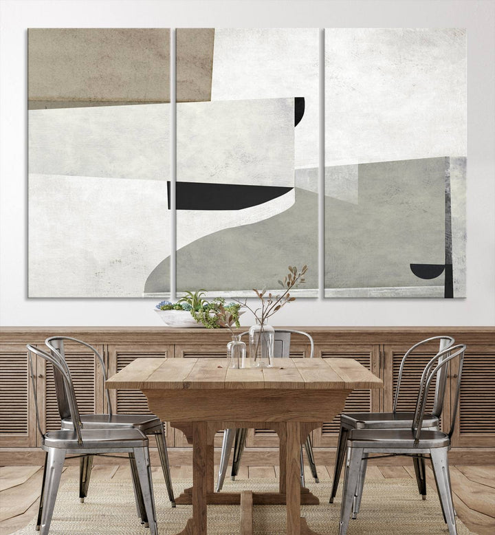 The Brown Gray Figures Abstract Wall Art Canvas Print is displayed as a triptych on a dark wall. The piece is gallery wrapped, offering a seamless finish and enhanced durability due to its UV-protective coating.