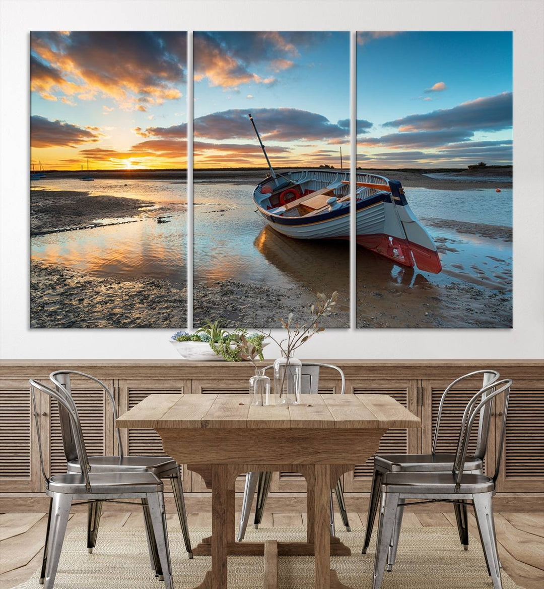 The "Small Boat At The Beach Sunset Wall Art Canvas Print," a three-panel masterpiece crafted on museum-quality canvas, hangs elegantly.