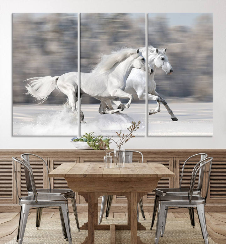 The "All The White Horses Wall Art Canvas Print" depicts a triptych of galloping white horses across a snowy landscape. These museum-quality canvases come with a UV-protective coating to maintain their stunning appearance over time.