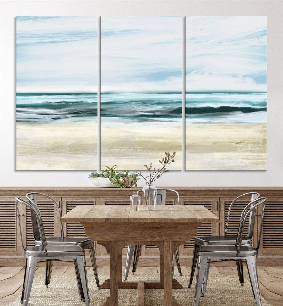 The room features the Ocean Abstract Wall Art Canvas Print, a triptych beach painting on museum-quality canvas with a gallery-wrapped finish and UV-protective coating.