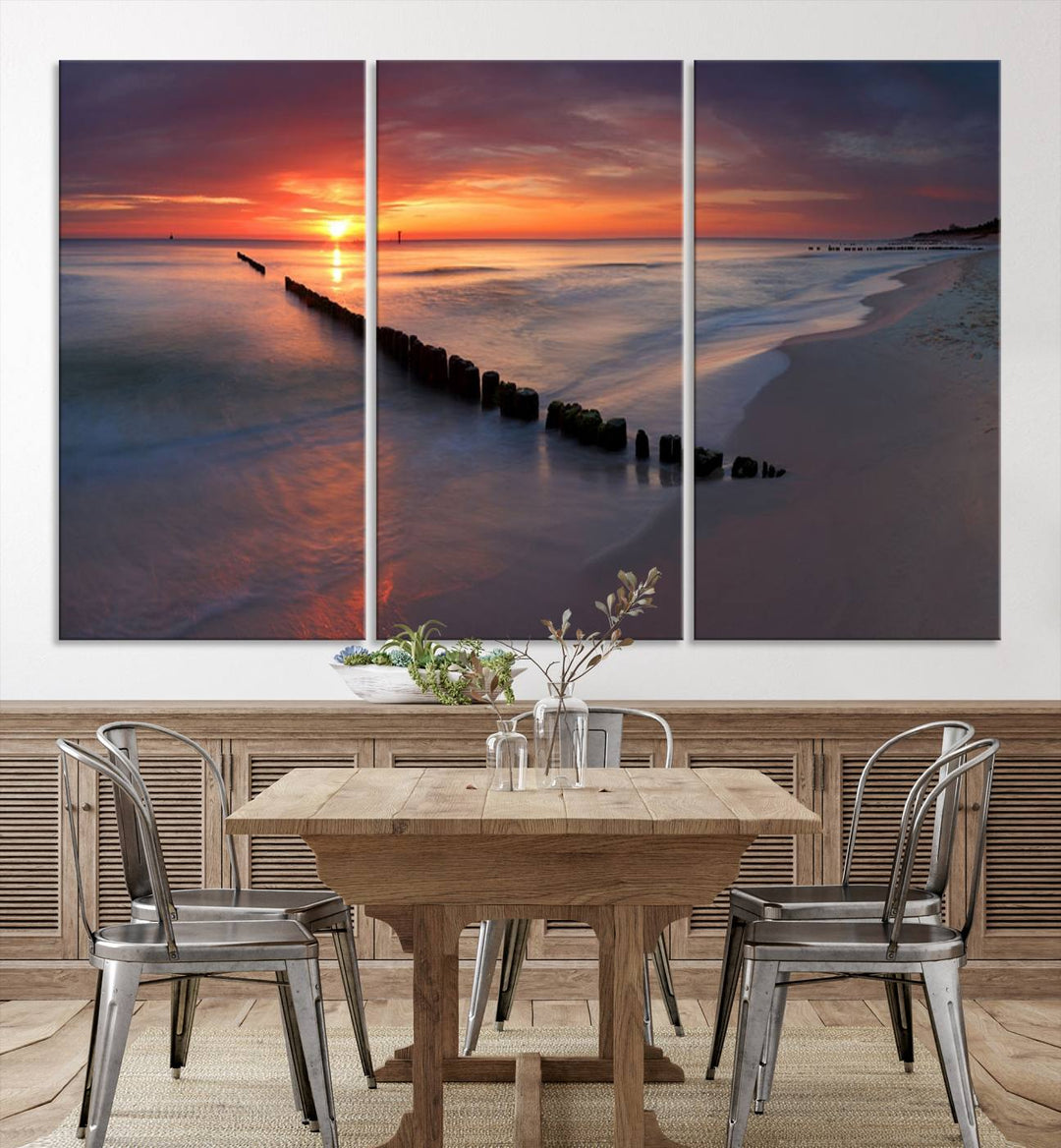 In a modern living room, the Sunset Beach Wall Art Canvas Print is displayed above. This triptych, printed on museum-quality canvas with a UV-protective coating, ensures lasting brilliance. It's ready to hang and brings an elegant touch to your space.