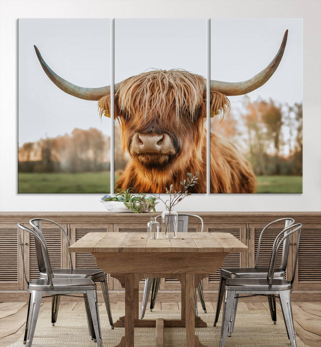 A Highland Cow Animal Scottish Cattle Art Print Farmhouse Wall Art Canvas Print hangs in the living room, adding a touch of rustic farmhouse decor.