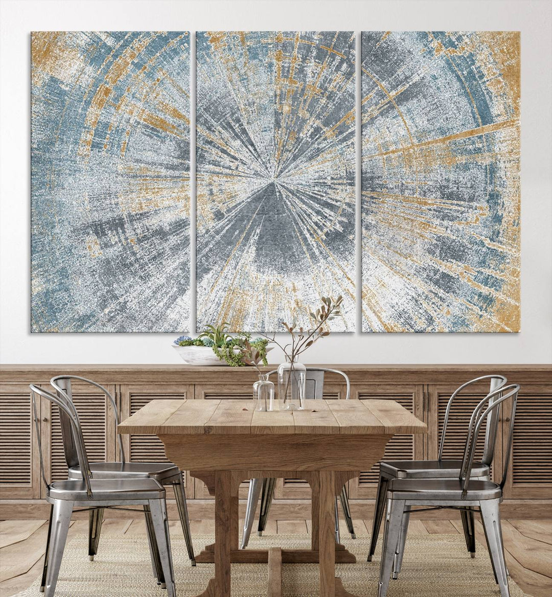 The Radiant Abstract Wood Rings Canvas Art, a modern triptych wall decor, enhances the contemporary style of the living room with its blue, white, and gold hues.